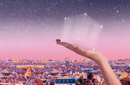 An expansive city skyline at dusk, featuring a hand reaching upwards toward a starry sky, with pink and purple hues blending into the horizon.