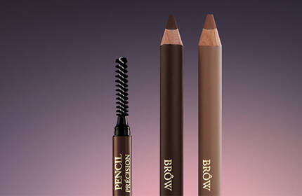 Three eyebrow pencils are displayed against a gradient background, featuring a spoolie brush on the left, with two brown pencils on the right.
