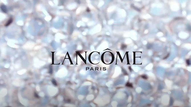 The image features the Lancome Paris logo prominently displayed against a shimmering background of sparkling gems.