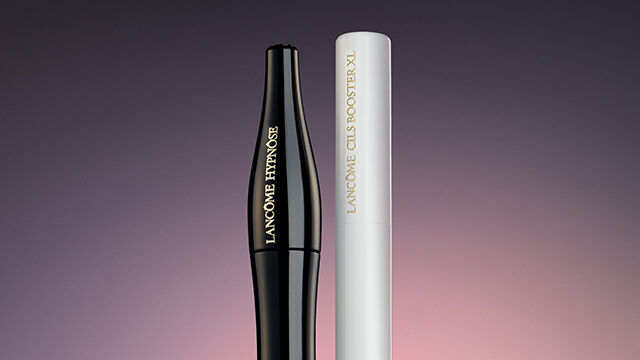 A black and a white eyeliner pencil positioned against a gradient background, showcasing their sleek designs and brand labels.