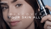A close-up of a woman holding a bottle of Lancome serum, with the text "Discover Your Skin Ally" overlaying the image.