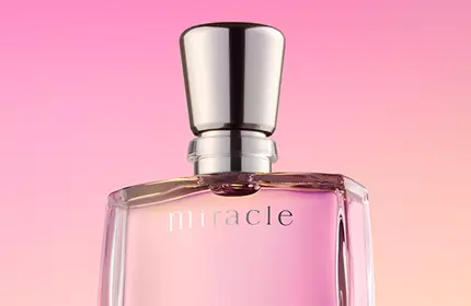 A clear glass perfume bottle labeled "Miracle" with a silver cap against a soft gradient background of pink and purple hues.