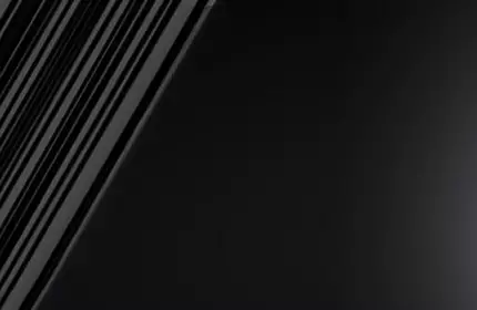 A close-up of a sleek black mascara tube next to a mascara wand, set against a gradient background that transitions from dark to light.